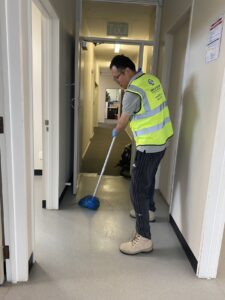 Office hallway floor being mopped by cleaning staff