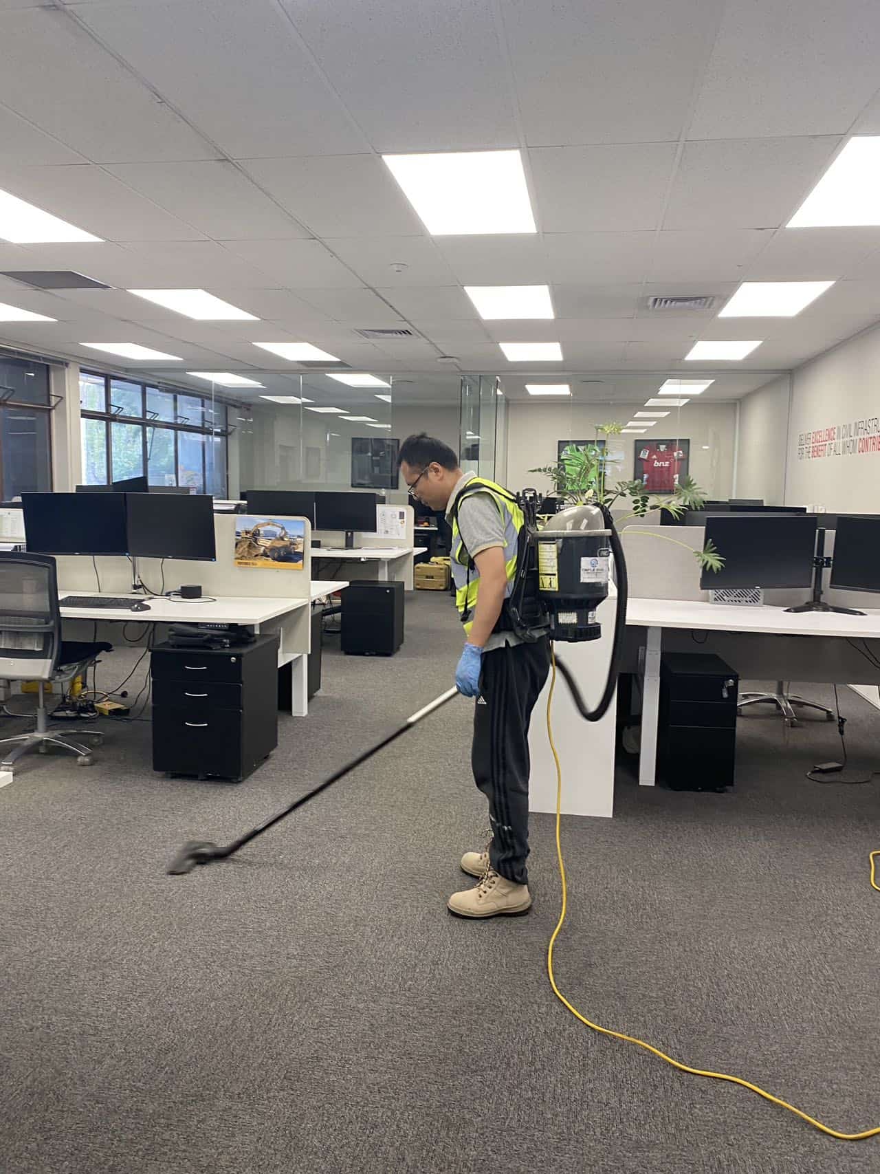 Triple Star Commercial Cleaning staff using a commercial-grade vacuum cleaner to deep clean office carpets in Auckland and Christchurch.