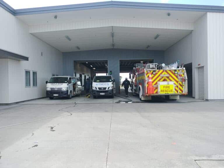 Triple Star Commercial Cleaning team performing professional cleaning services at a fire station, with company vehicles present in Auckland and Christchurch