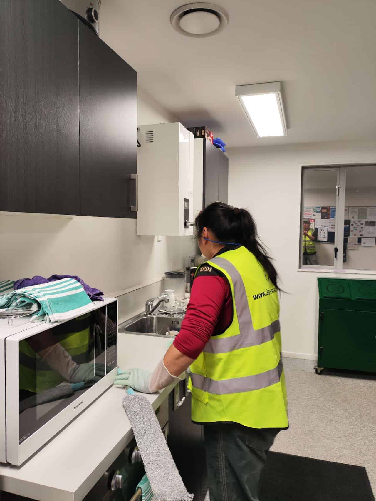 Triple Star Commercial Cleaning staff deep cleaning an office kitchenette, maintaining hygiene and cleanliness in Christchurch and Auckland offices.