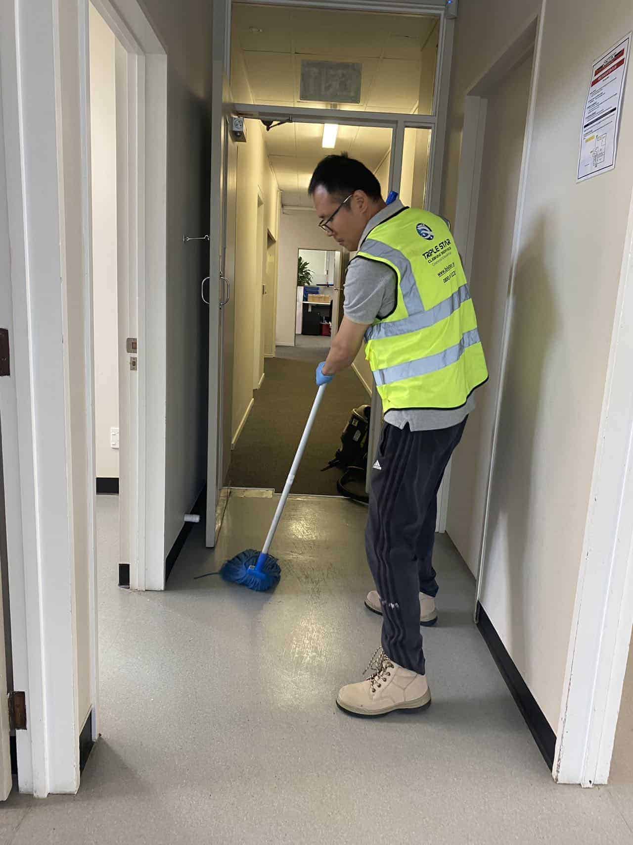 Triple Star Commercial Cleaning team mopping office hallways for a clean and professional work environment in Christchurch and Auckland.